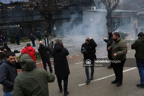 Opposition protesters in Kosovo use flares and tear gas to protest against a war crimes court